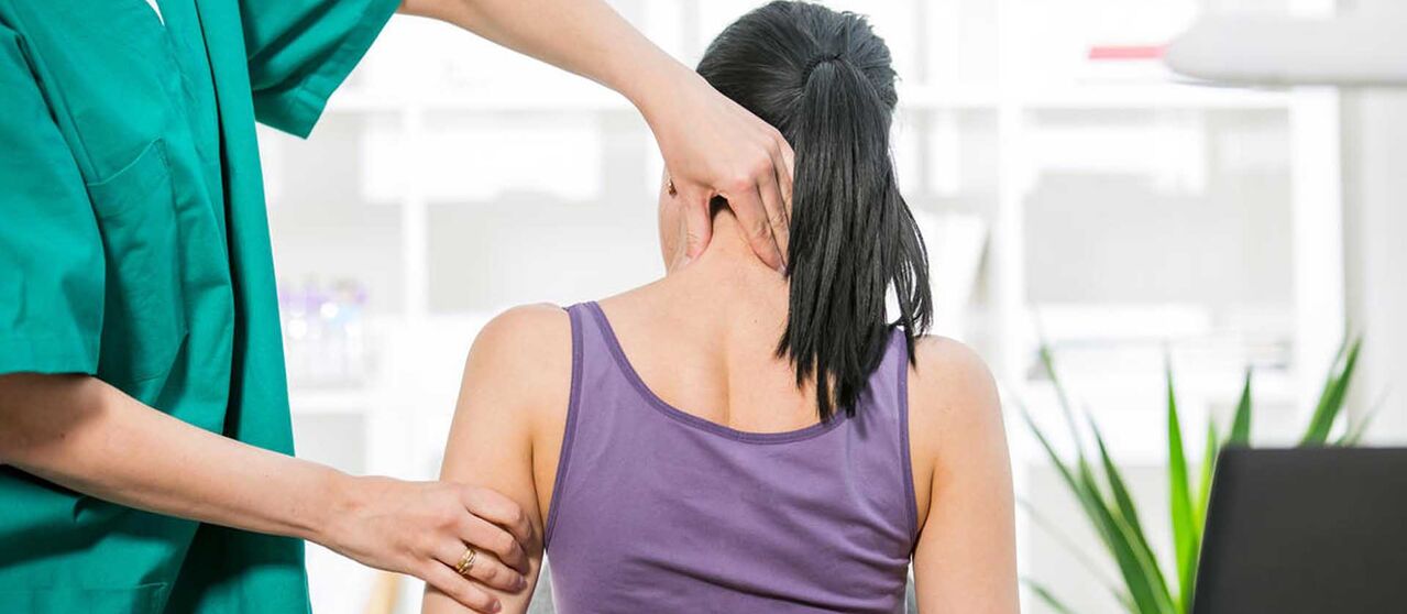 Patient with neck pain examined by doctor